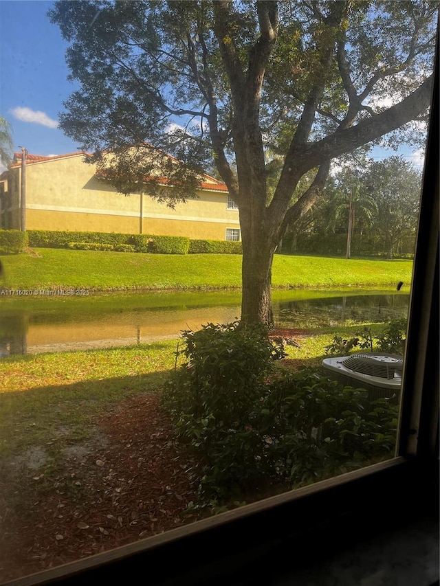 view of home's community featuring a water view and a lawn