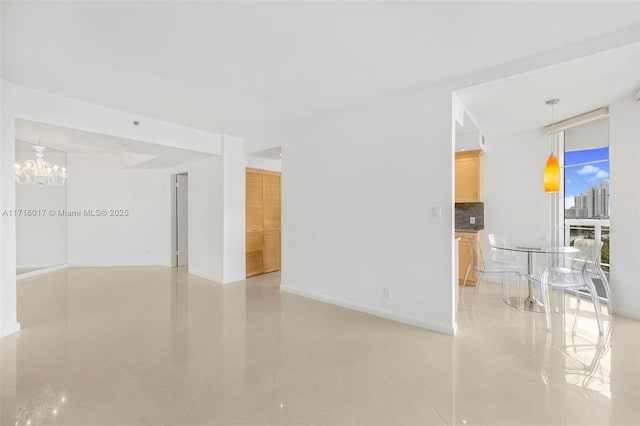 spare room with floor to ceiling windows, light tile patterned floors, and an inviting chandelier