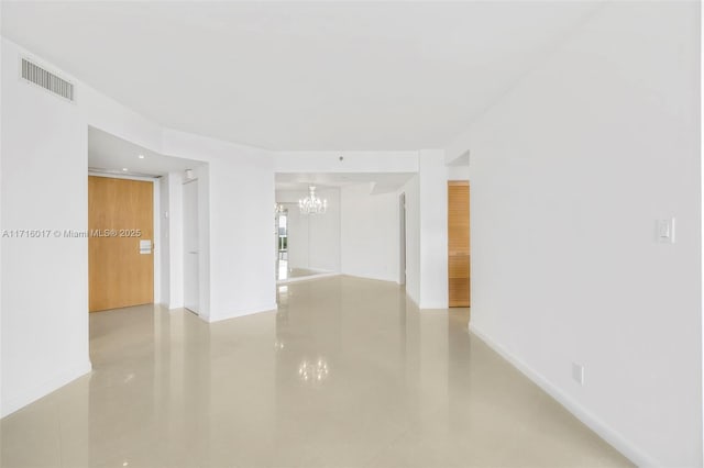 empty room featuring a chandelier