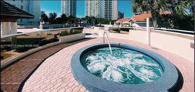 view of swimming pool featuring a community hot tub