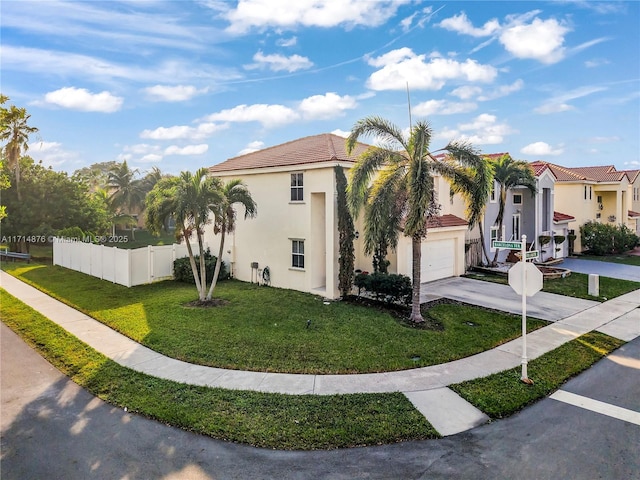 view of home's exterior featuring fence, stucco siding, concrete driveway, and a lawn