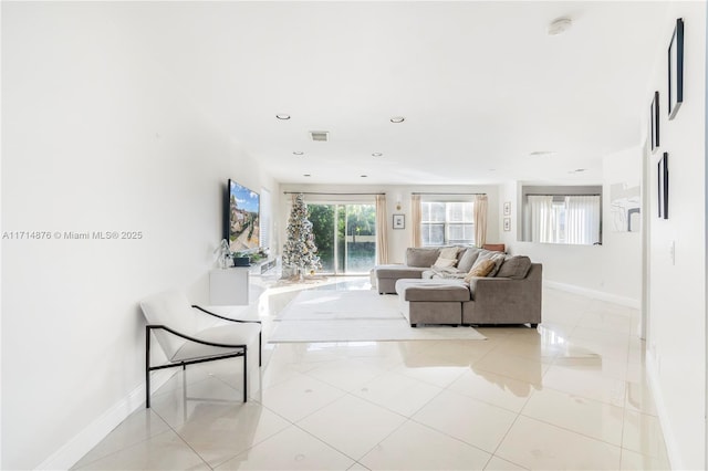 unfurnished living room with light tile patterned flooring