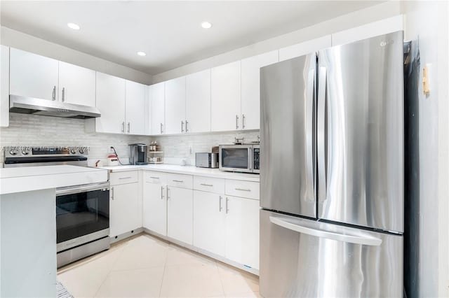 kitchen featuring decorative backsplash, white cabinetry, light tile patterned floors, and appliances with stainless steel finishes