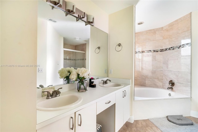 bathroom featuring shower with separate bathtub and vanity