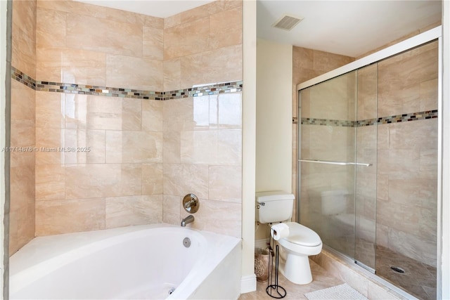 bathroom featuring toilet and shower with separate bathtub