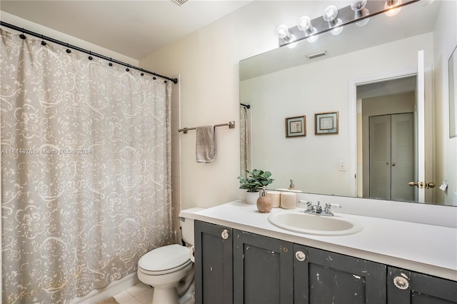 bathroom featuring tile patterned flooring, vanity, and toilet