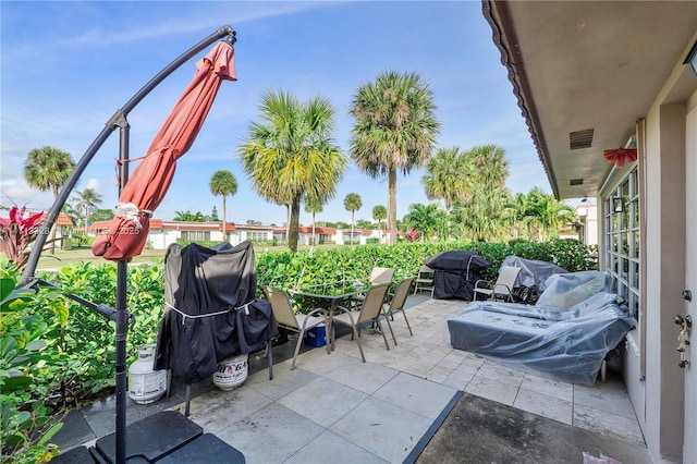 view of patio / terrace featuring visible vents, a grill, and outdoor dining space