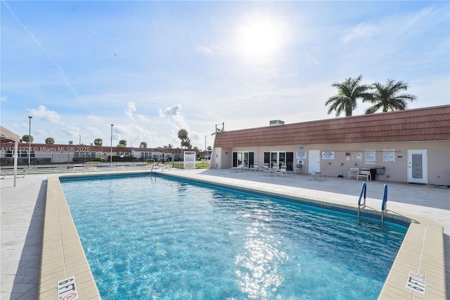 pool featuring a patio and fence