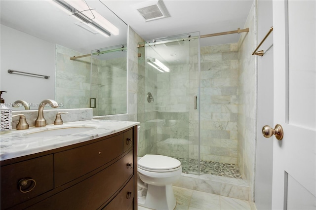 bathroom with vanity, a shower with shower door, and toilet