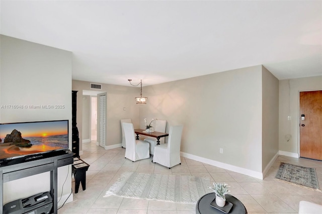 dining space featuring a notable chandelier and light tile patterned flooring