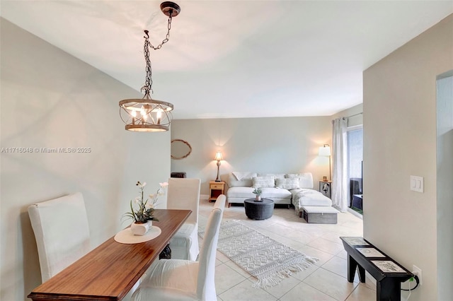 living room with light tile patterned floors and a chandelier