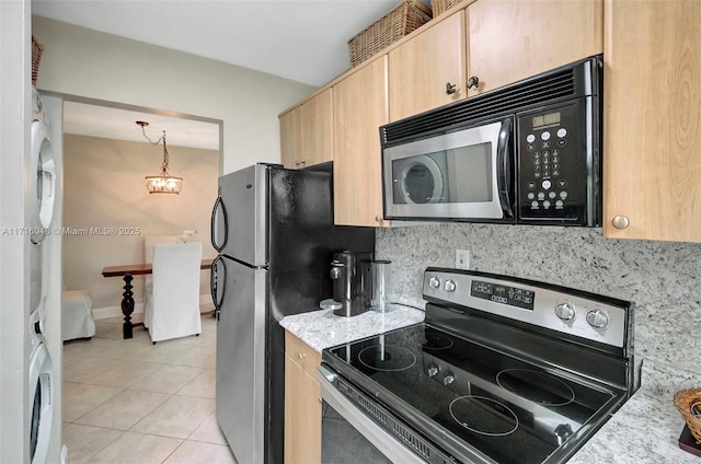 kitchen with light tile patterned flooring, light brown cabinets, stainless steel appliances, and tasteful backsplash