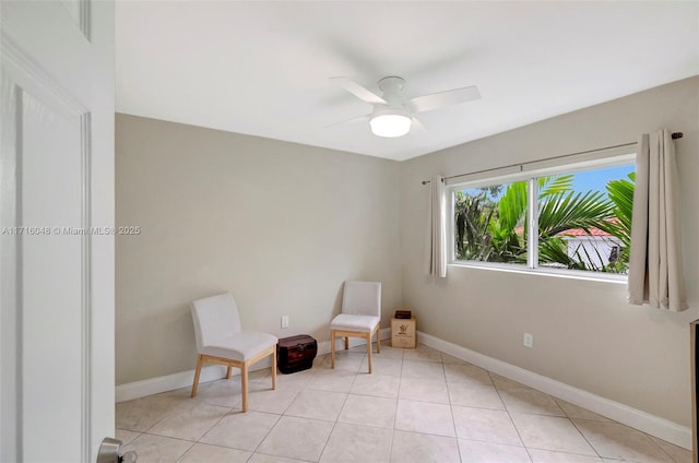 sitting room featuring ceiling fan and light tile patterned floors