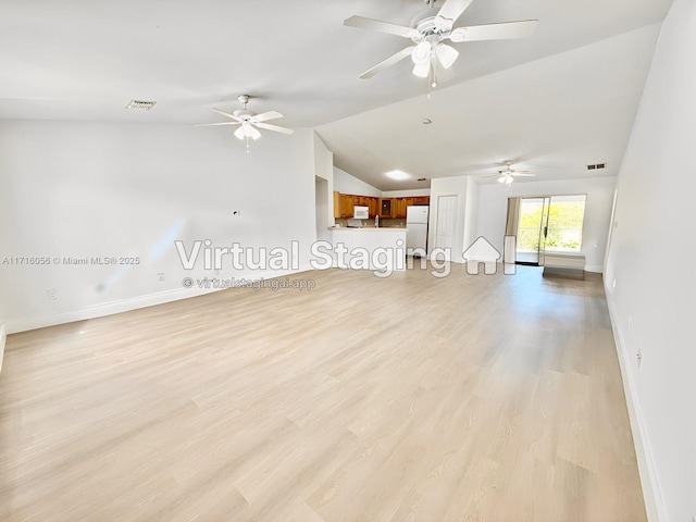 unfurnished room featuring light wood-type flooring, vaulted ceiling, and ceiling fan