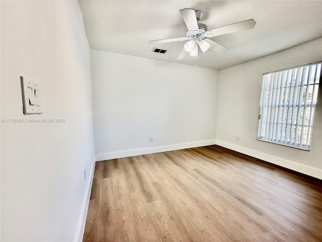 spare room featuring ceiling fan and light hardwood / wood-style floors