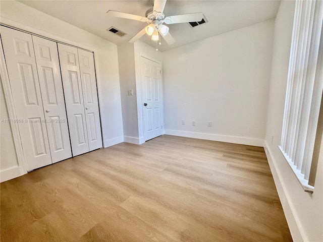 unfurnished bedroom with ceiling fan, light hardwood / wood-style floors, and a closet