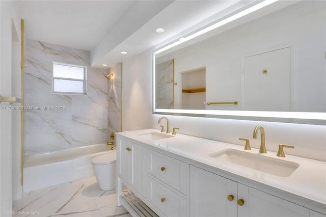 full bathroom featuring vanity, toilet, and tiled shower / bath