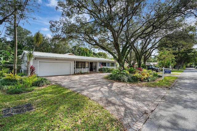 single story home with covered porch and a garage