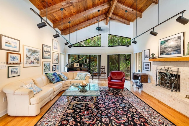 living room with wooden ceiling, high vaulted ceiling, beamed ceiling, wood-type flooring, and a fireplace