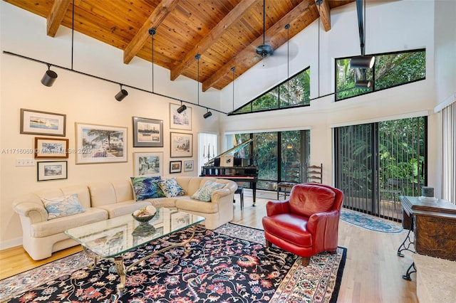 living room with high vaulted ceiling, wooden ceiling, beamed ceiling, hardwood / wood-style floors, and plenty of natural light