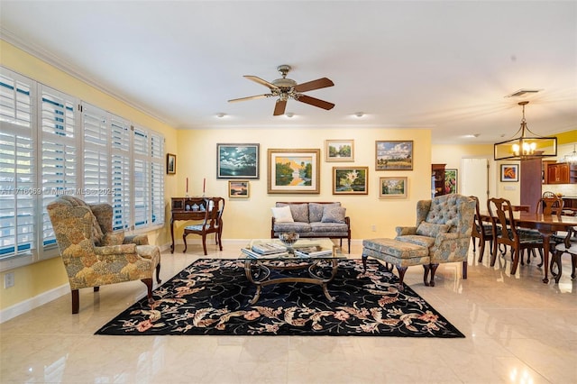 living room with ceiling fan with notable chandelier and ornamental molding