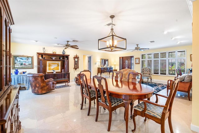 dining room with light tile patterned floors and ceiling fan with notable chandelier