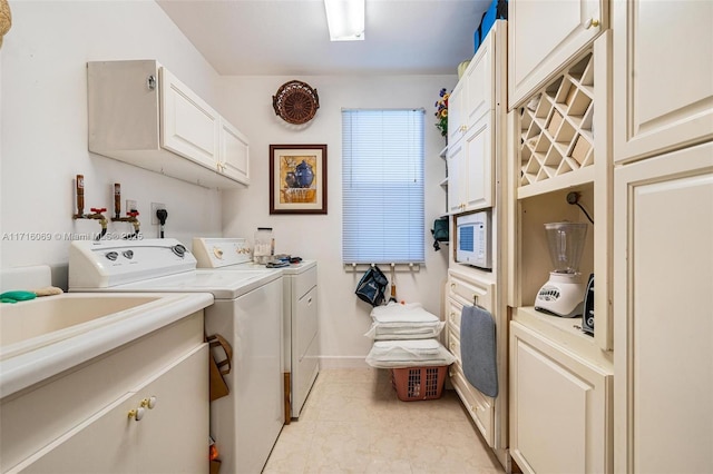 laundry area featuring cabinets and independent washer and dryer