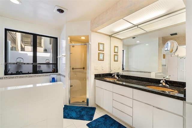 bathroom with vanity, tile patterned floors, and walk in shower