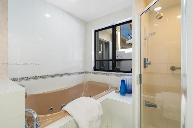 bathroom featuring plus walk in shower and tile walls