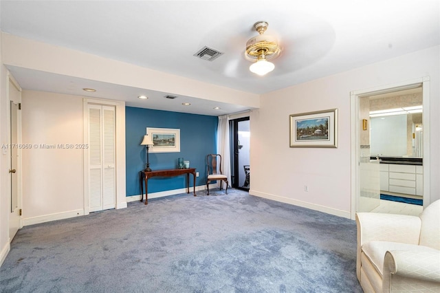 sitting room with carpet floors and ceiling fan