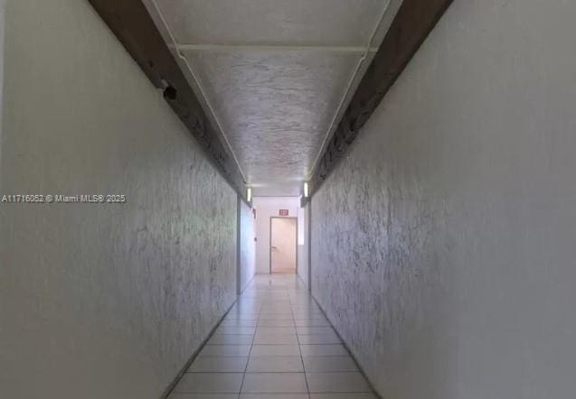 hall featuring light tile patterned floors