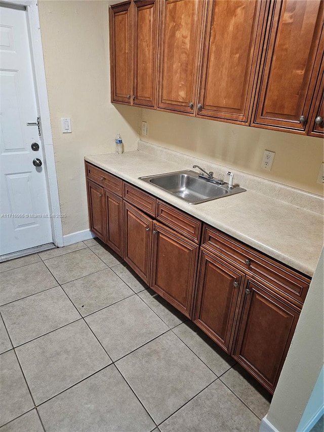 kitchen featuring light tile patterned floors and sink