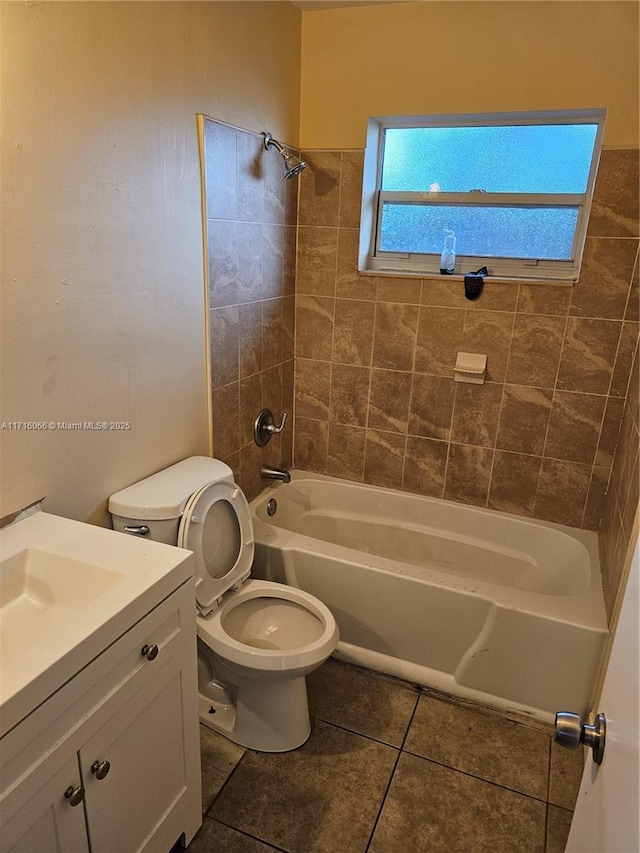 full bathroom featuring tile patterned floors, vanity, toilet, and tiled shower / bath