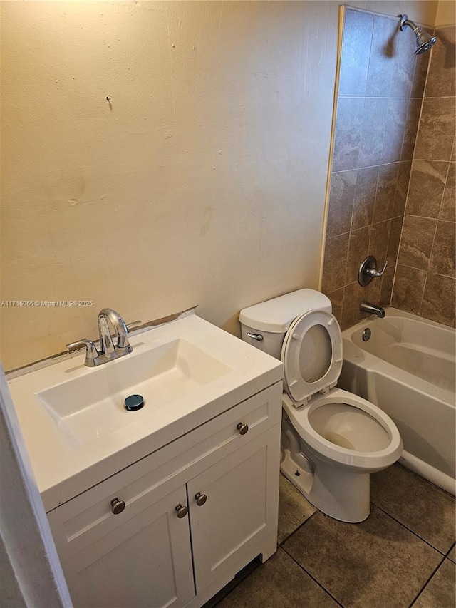 full bathroom featuring tile patterned flooring, tiled shower / bath combo, toilet, and vanity