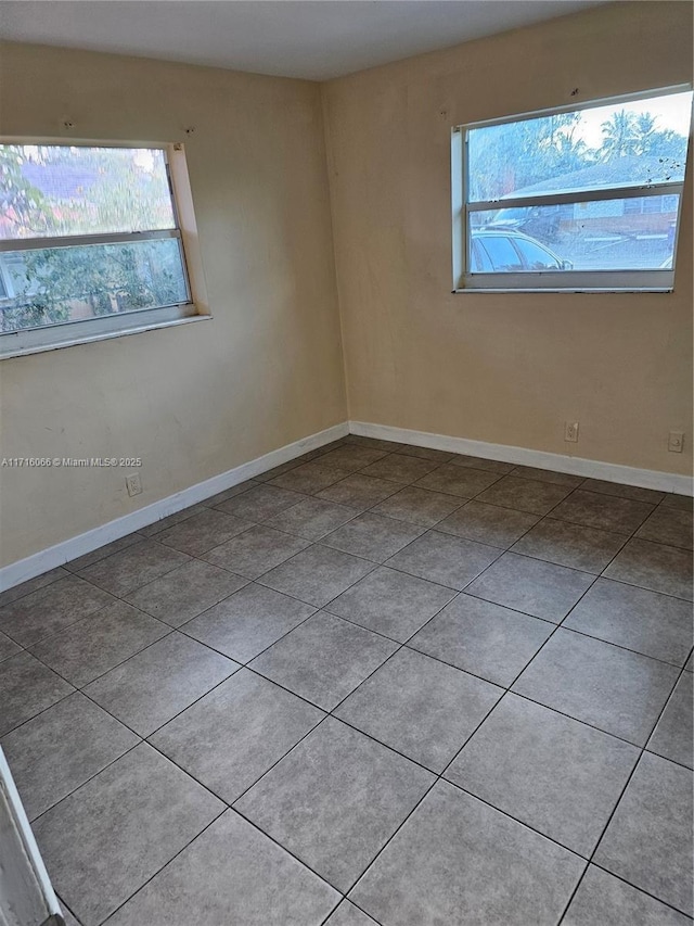 spare room with light tile patterned floors