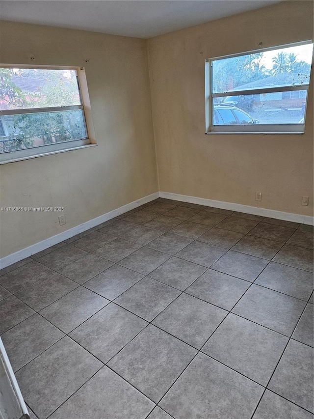 unfurnished room featuring light tile patterned floors