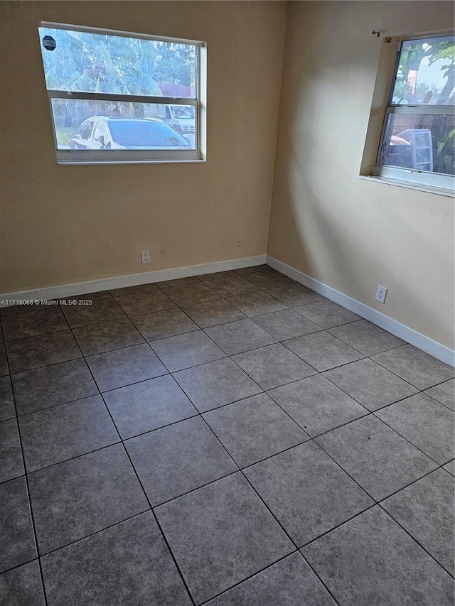 spare room with tile patterned flooring