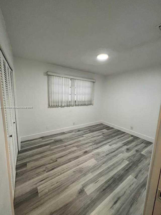 unfurnished bedroom featuring a closet and hardwood / wood-style flooring