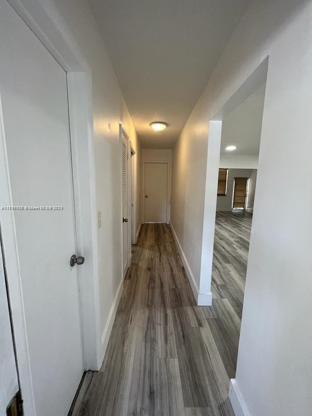 hallway with hardwood / wood-style floors