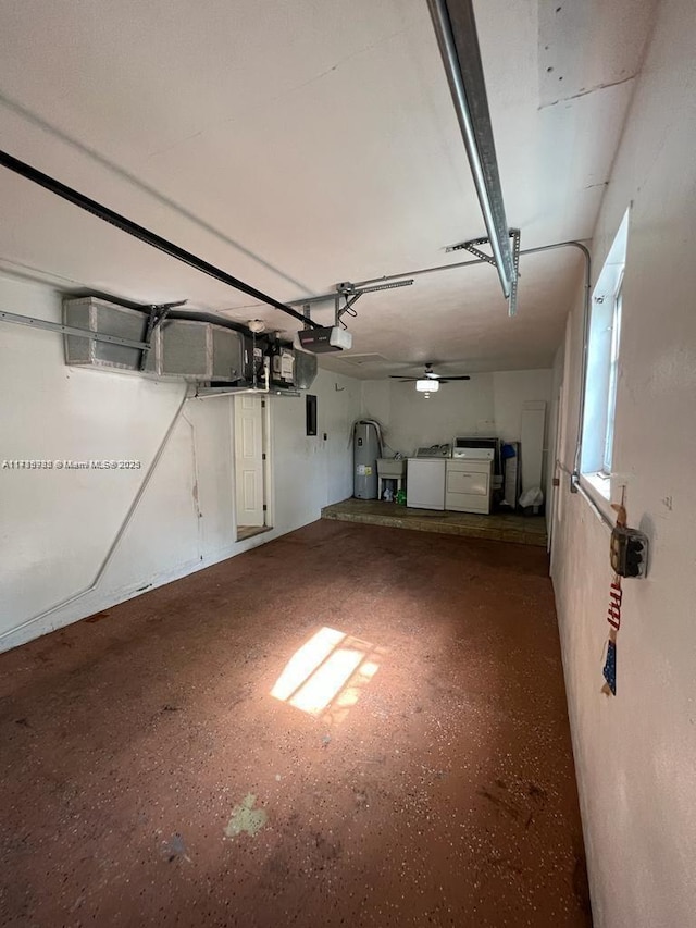 garage featuring washer and dryer, electric water heater, and a garage door opener