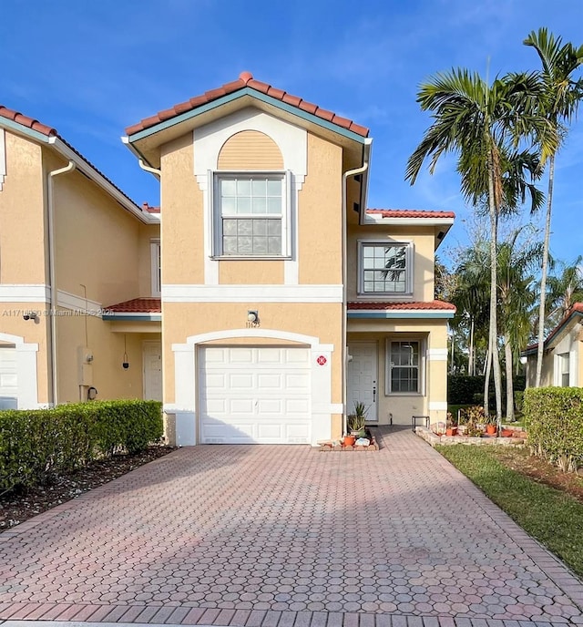 mediterranean / spanish-style home with a garage