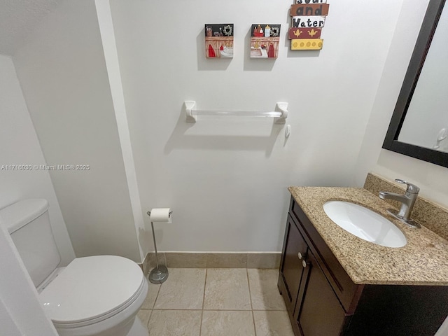 bathroom featuring tile patterned floors, vanity, and toilet