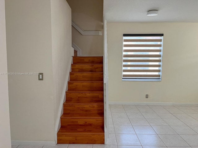 stairway with tile patterned floors