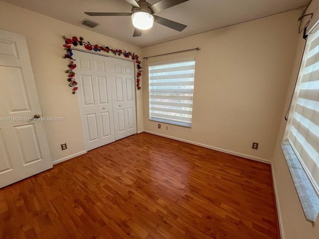 unfurnished bedroom featuring a closet, ceiling fan, and hardwood / wood-style flooring