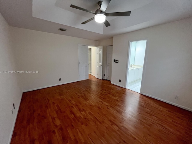 spare room featuring hardwood / wood-style flooring, ceiling fan, and sink