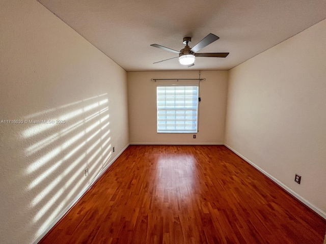 spare room featuring wood-type flooring and ceiling fan