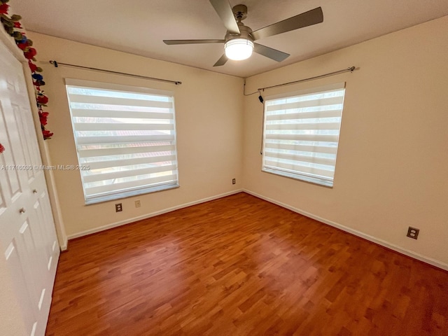 spare room featuring ceiling fan and hardwood / wood-style flooring