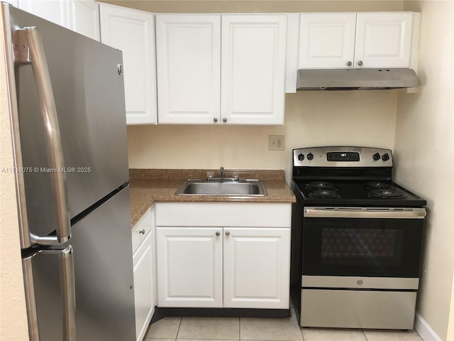 kitchen featuring white cabinets, light tile patterned floors, stainless steel appliances, and sink