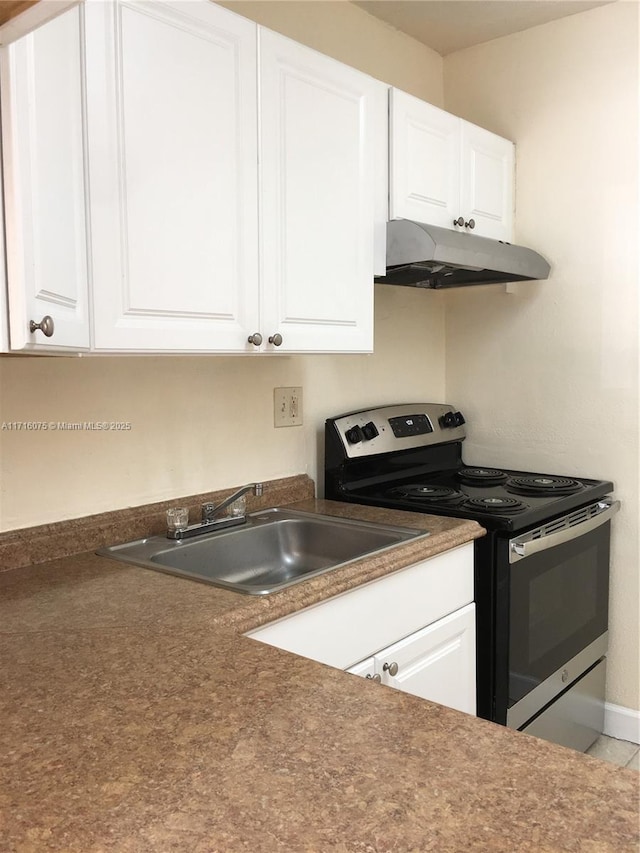 kitchen featuring stainless steel range with electric stovetop, white cabinets, and sink