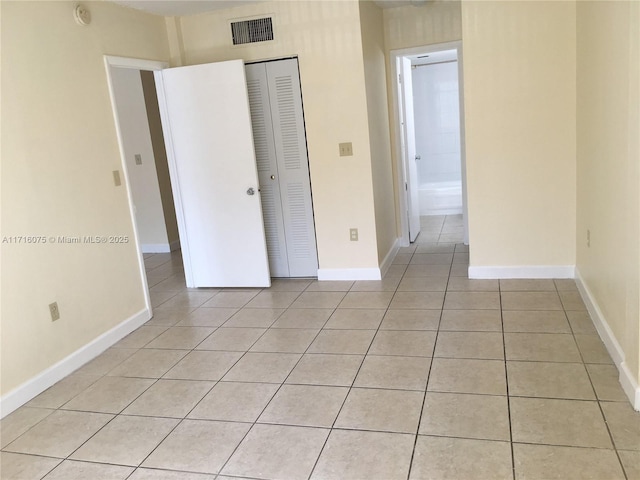 unfurnished bedroom with a closet and light tile patterned floors